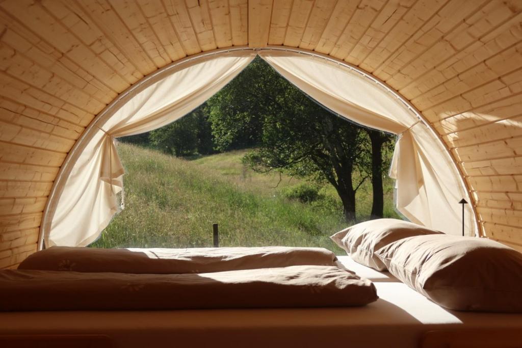a room with a window with a view of a field at Übernachtungsfaß in Alpirsbach