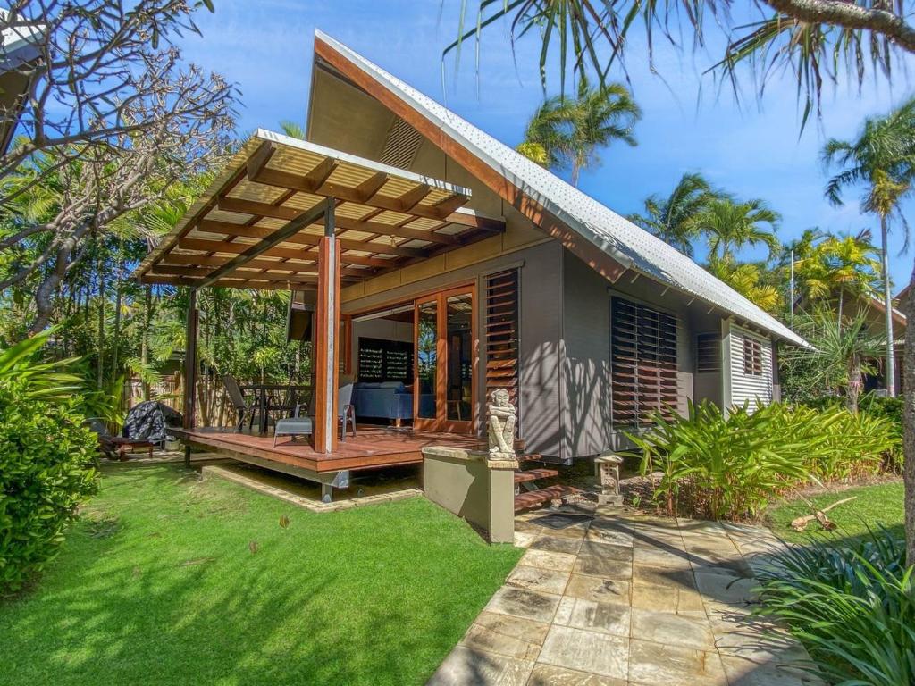 a small house with a deck and a patio at Pure Magnetic Villa 4 in Nelly Bay