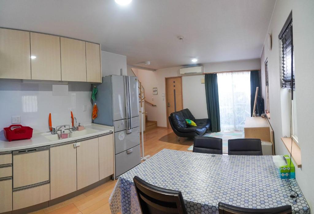 a kitchen with a table and a dining room at Katsuragawa House in Kami-tobachō