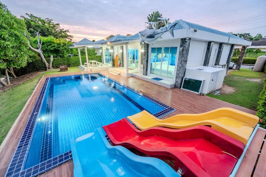 a swimming pool in front of a house at Shark House - Pool Villa RB13 in Ban Klam