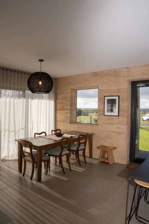 a dining room with a wooden table and chairs at The Well - Peterborough in Peterborough
