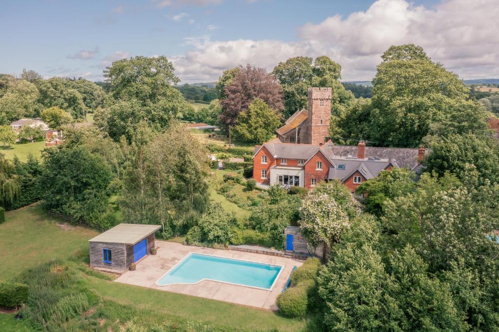 an aerial view of a house with a swimming pool at Finest Retreats - The Old Schoolhouse at Penrhos in Raglan