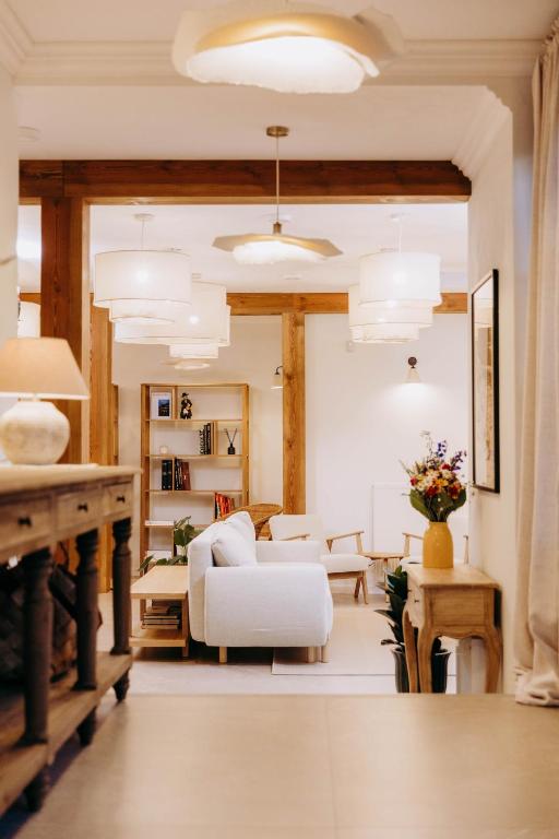 a living room with a white couch and a table at Luna in Kazimierz Dolny