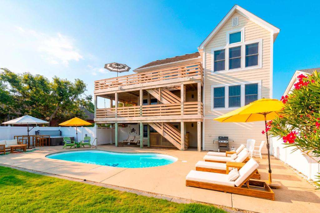 a house with a deck and a swimming pool at Duck Resort with Ocean Views Pool HotTub Elevator in Kitty Hawk Beach