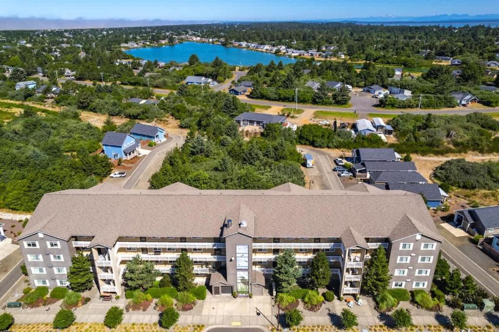 an aerial view of an apartment complex with a lake at 2BR Oyhut Bay Condo Fireplace Private Deck in Ocean Shores