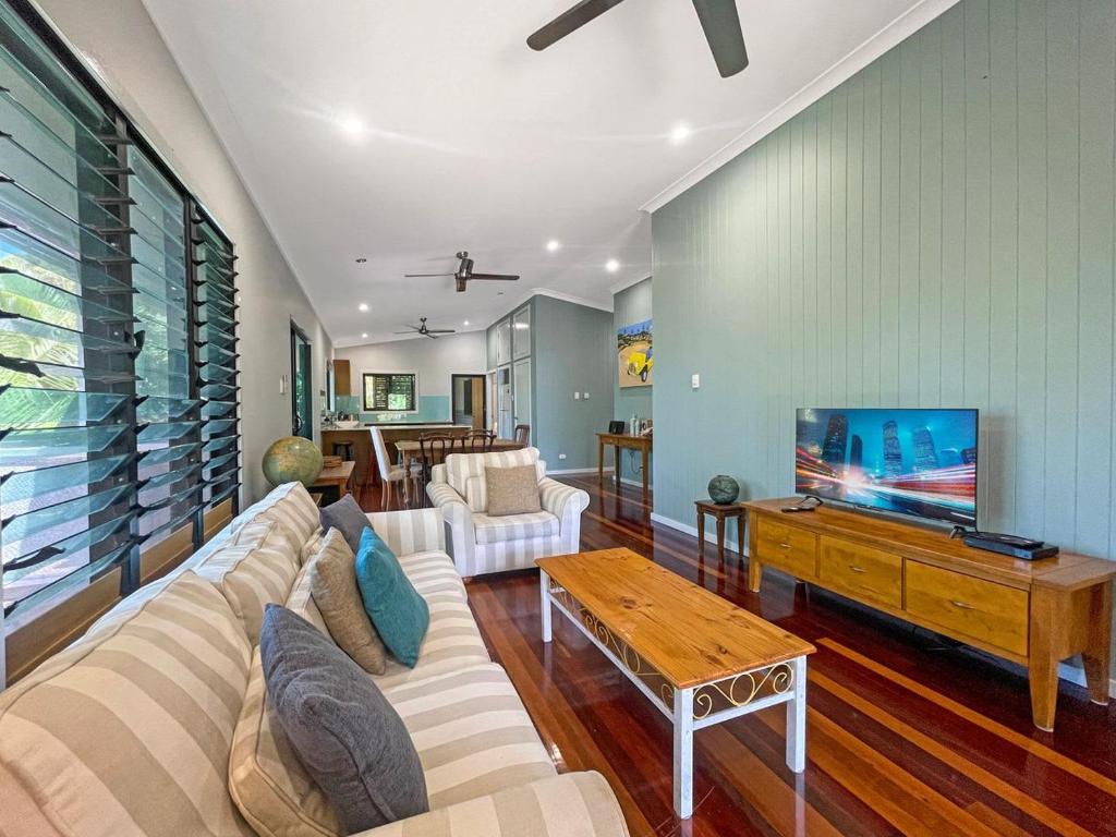 a living room with a couch and a tv at Debs Shed in Arcadia