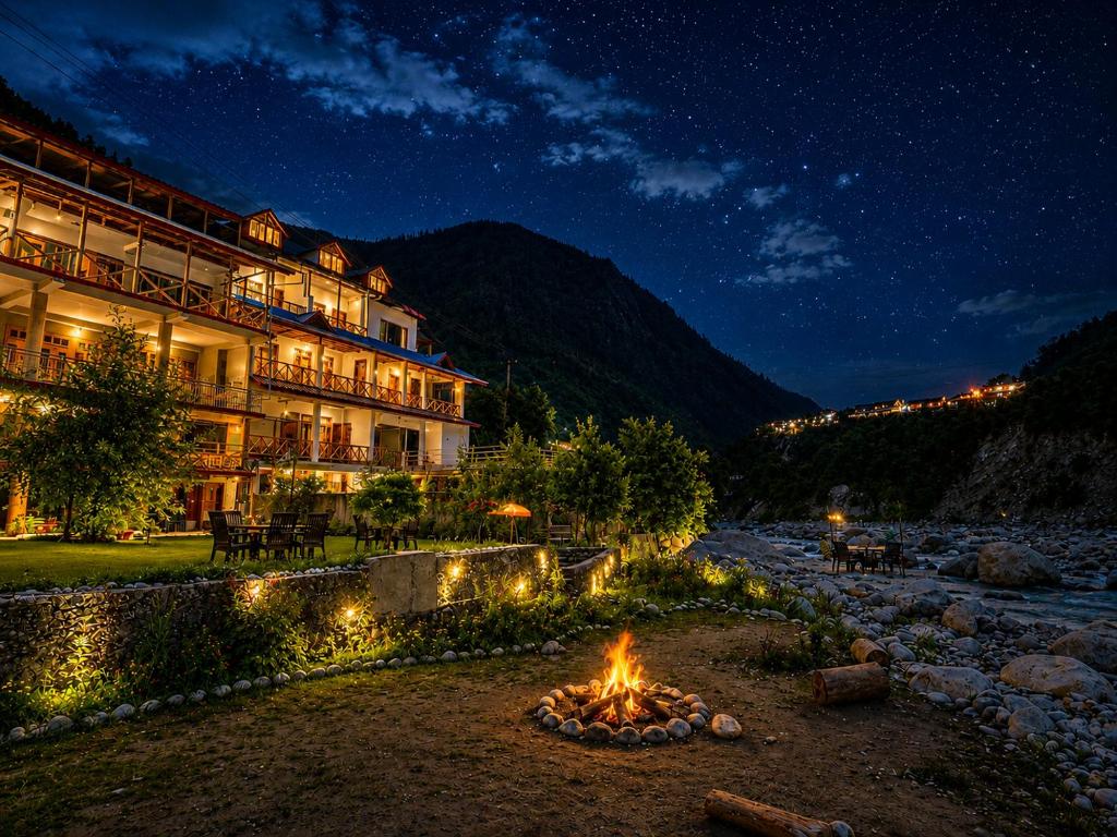 a fire pit in front of a hotel at night at Sneha Riverside Cottage, Tirthan Valley - Best selling cottage in Jibhi 2025-26 in Jibhi