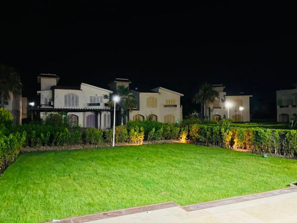 a large yard in front of a house at night at Luxury Duplex Villa for Rent in Dawwār Muḩammad Abū Shanab
