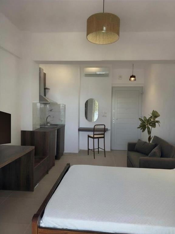 a living room with a couch and a table at Paliovarka Rooms in Mitika