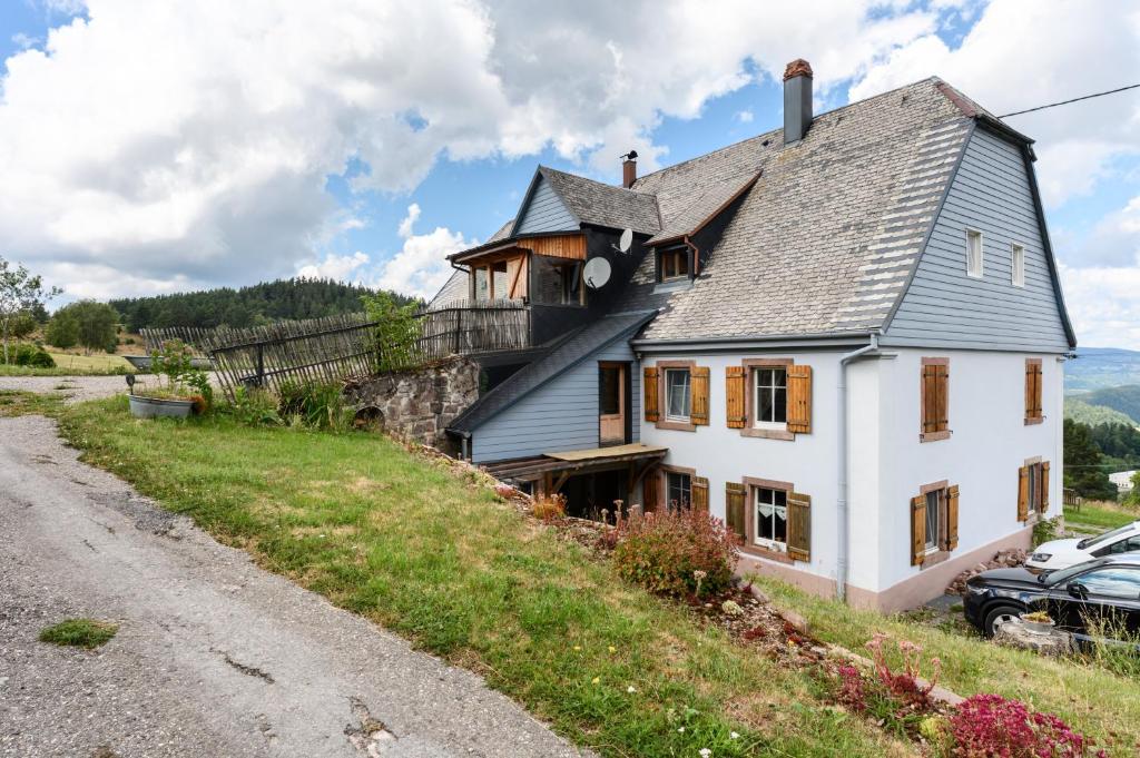 a house on the side of a hill at Chambres d'hôtes, Les Combes in Orbey