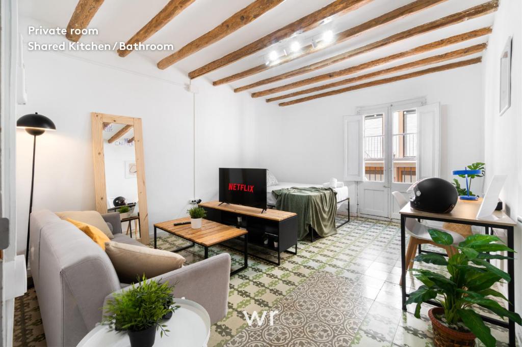 a living room with a couch and a table at weroomies - Pons Icar H3 in Tarragona