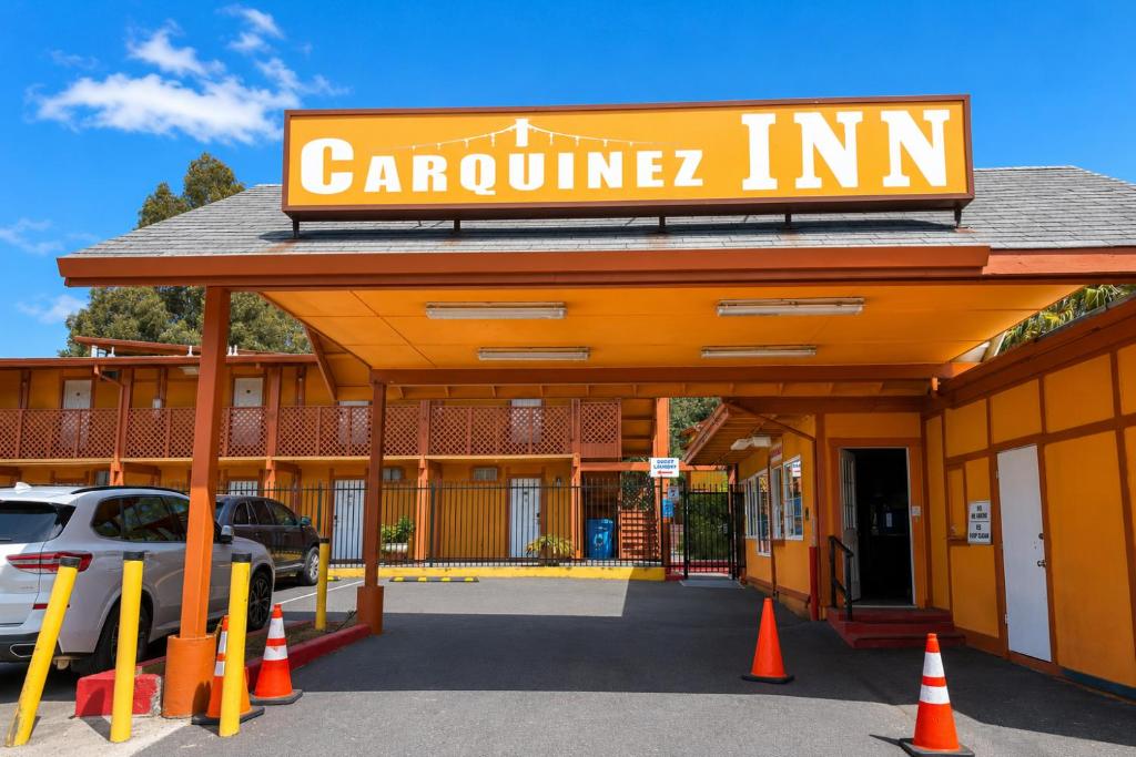 a carolina inn sign on the front of a building at Carquinez Inn Vallejo I 80 Near Napa Valley in Vallejo