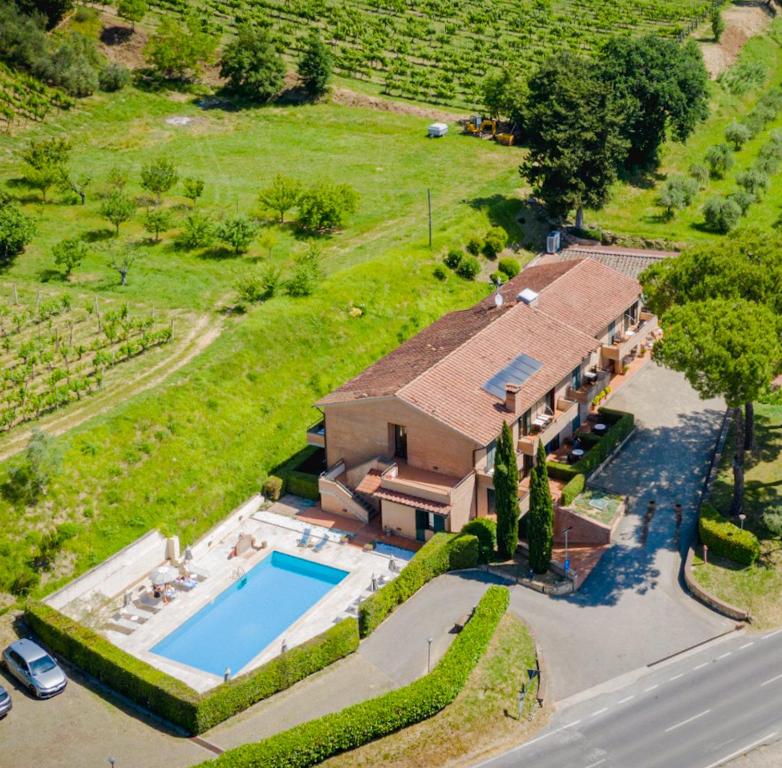 an aerial view of a house with a swimming pool at Hotel Le Colline in San Gimignano