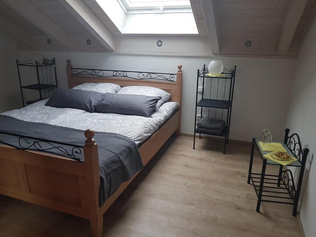 a bedroom with a large bed with a skylight at Double room 75 sqm between Augsburg and Munich in Wiedergeltingen