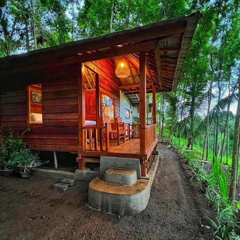 a wooden cabin in the middle of a forest at Fuma Bungalow Tetebatu in Tetebatu