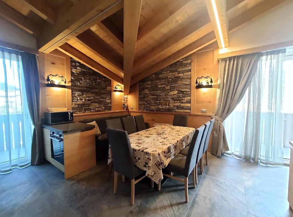 a dining room with a table and chairs in a room at Al Toscana in Andalo