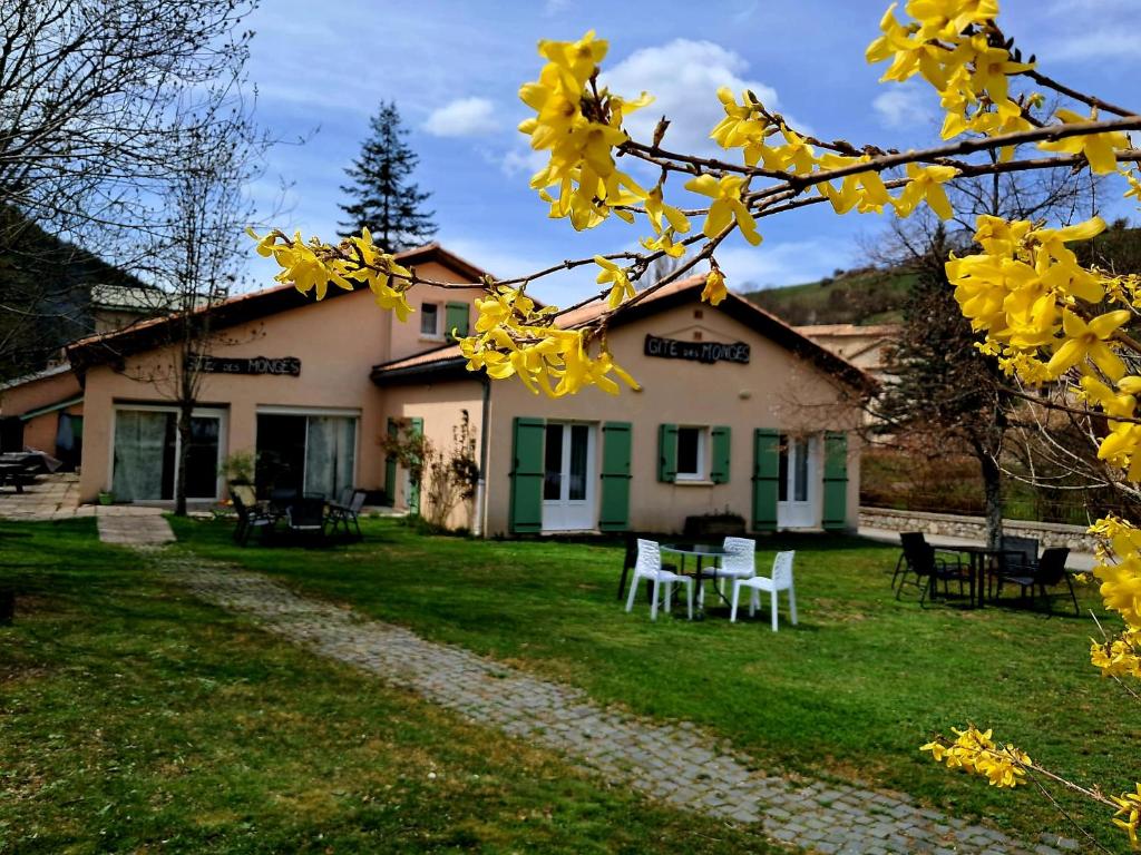 a house with yellow flowers in front of it at Gite des Monges in Authon