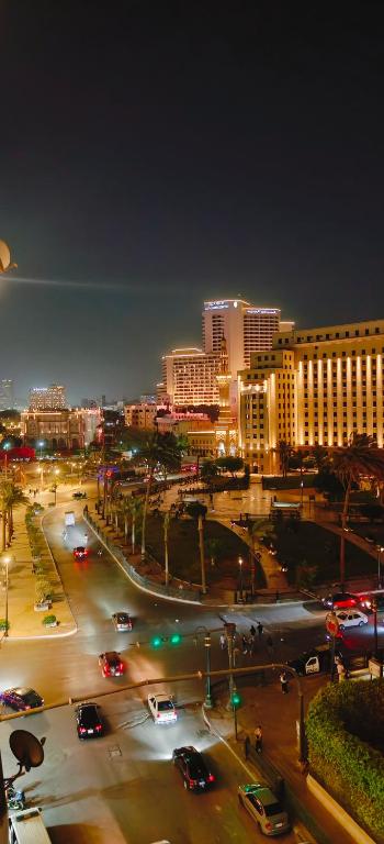 a city at night with cars on a street at suites in cairo downtown in Cairo