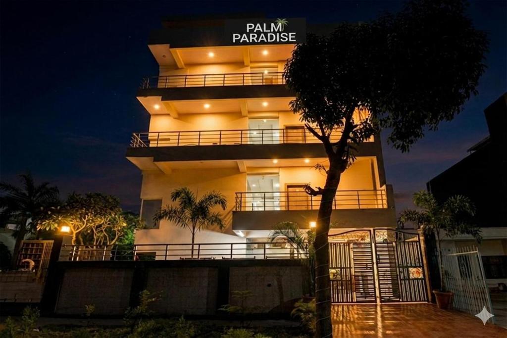a building with a sign that reads palm paradise at Hotel Palm Paradise in Noida