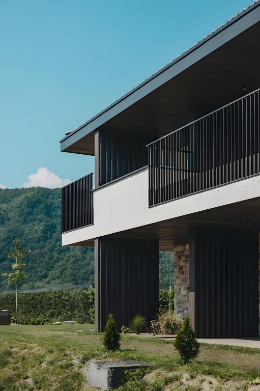 a black and white building with mountains in the background at New Opening Grafferhof in Bolzano