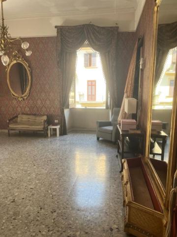a living room with a couch and a mirror at Coremi Naples in Naples