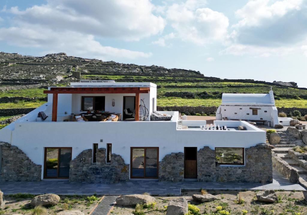 a house in the middle of a field at Ktima Lipsi, Panorama Pool Views in Klouvas