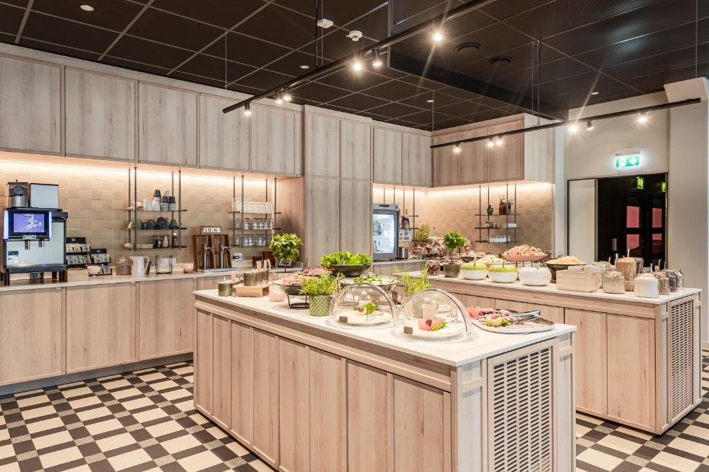 a restaurant with a buffet line with food at Quality Hotel Sundsvall in Sundsvall