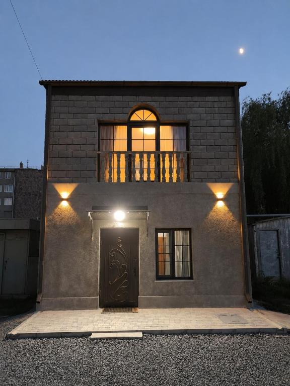 a brick house with a door and a window at Family House in Sevan