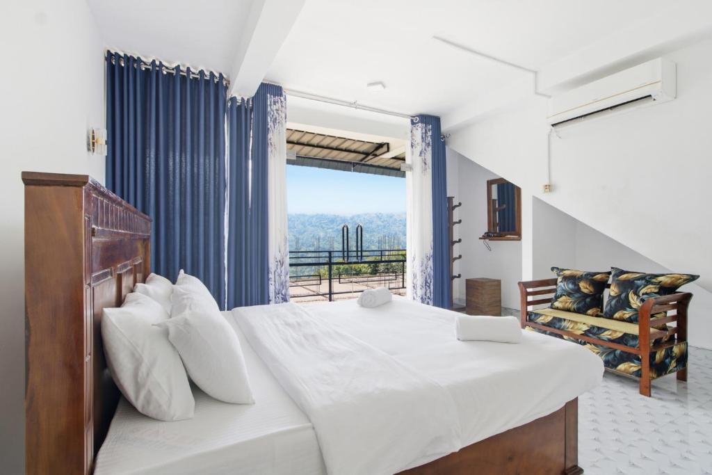 a bedroom with a bed and a large window at Why Not Guest House, Ella in Ella