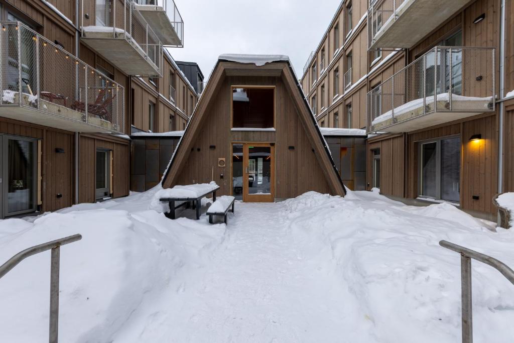 a pile of snow in front of a building at Twintip Apartments in Åre