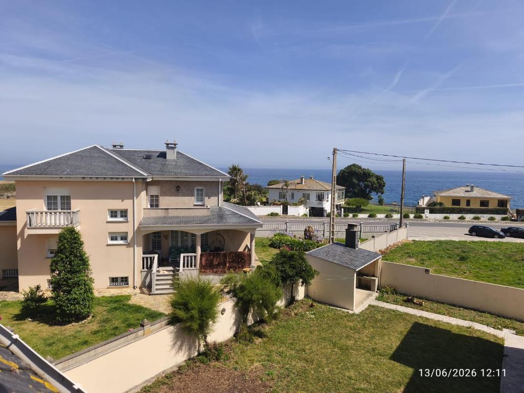 an aerial view of a house with the ocean in the background at ADOSADO Avda BREOGAN 71 in Foz