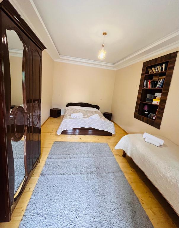 a bedroom with two beds and a rug at Qedani in Ch'k'valeri