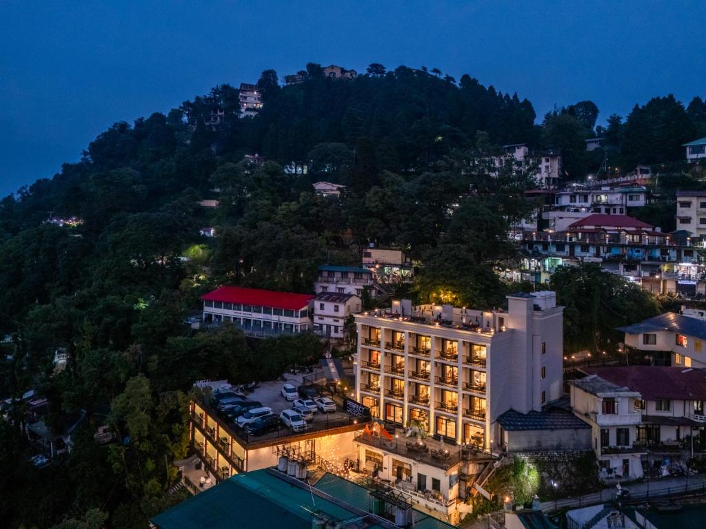 a view of a city at night with a mountain at Perfectstayz Prime - 2 min walk to mall road in Mussoorie