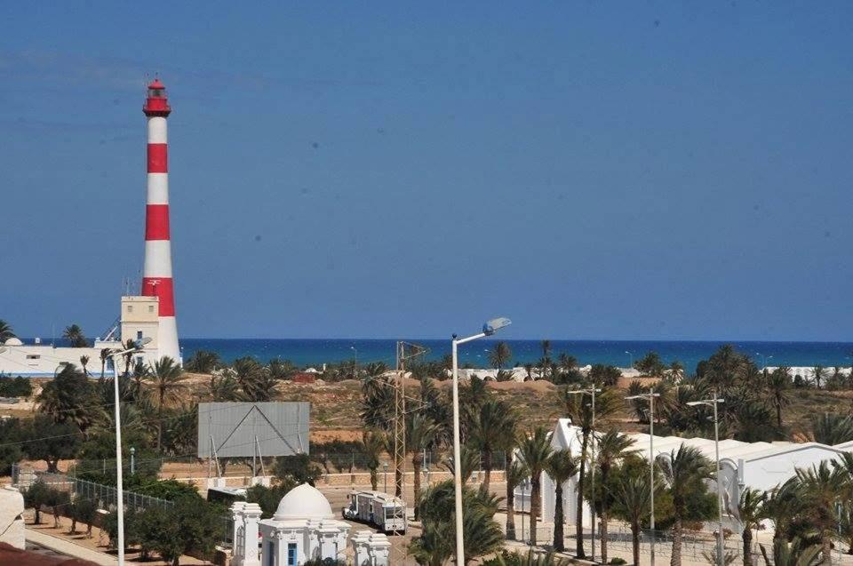 a lighthouse with a red and white lighthouse at Résidence PHILA Djerba in Djerba