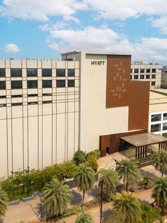 an office building with a sign on the side of it at Hyatt Raipur in Raipur