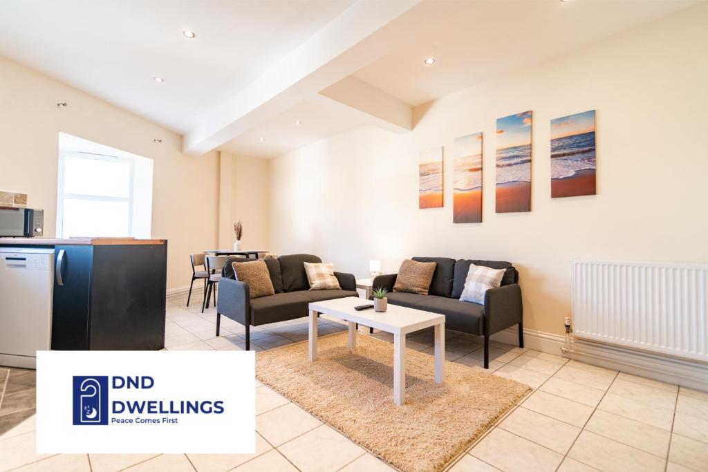 a living room with a couch and a table at Stylish 2 Bed Flat - 1 Bath - Parking - Harbour and Centre in Folkestone