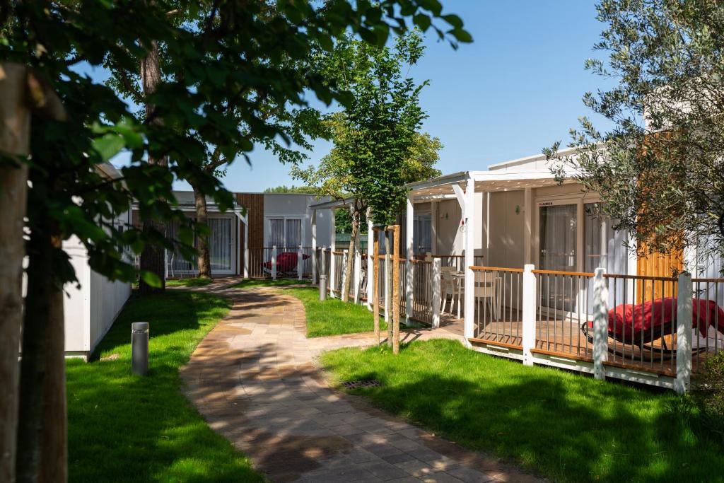 a row of houses with a fence at Camping Village Garden Paradiso in Cavallino-Treporti
