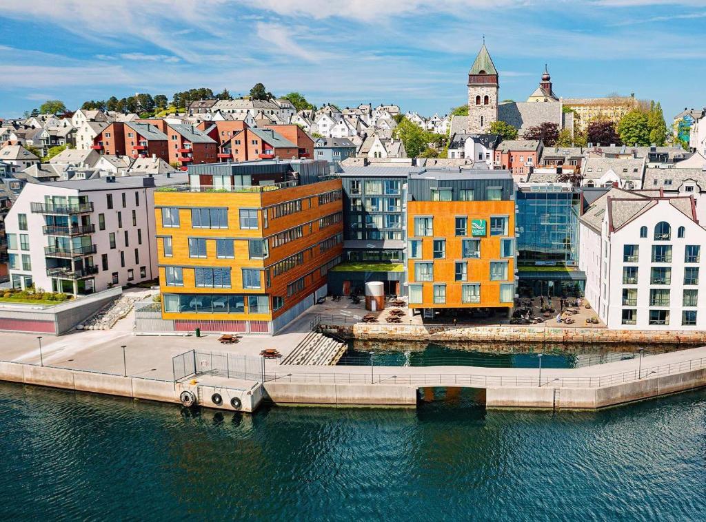 a city with colorful buildings on the water at Quality Hotel Waterfront in Ålesund