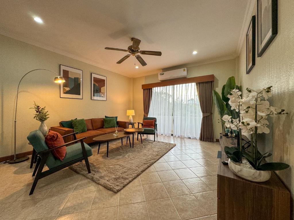 a living room with a couch and a table at View Talay Longstay Hotel & Suites in Jomtien Beach