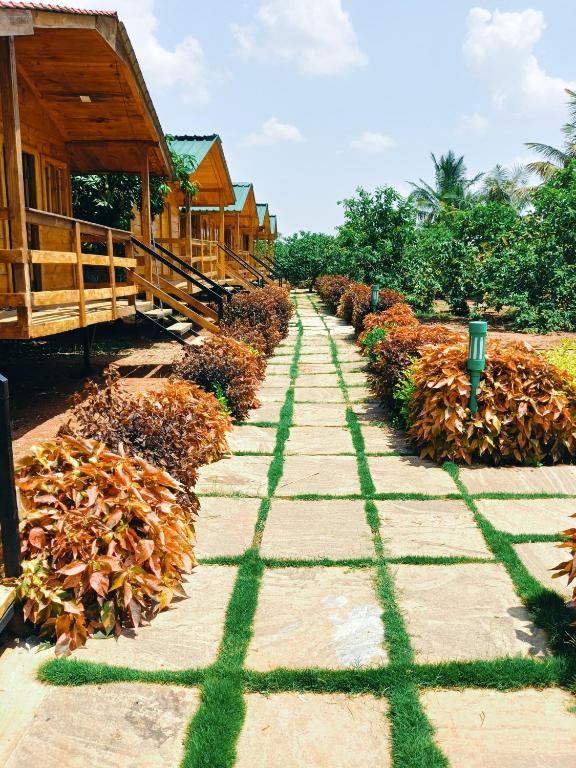 a stone path in front of a house at Nenapu Resorts in Oddarahalli