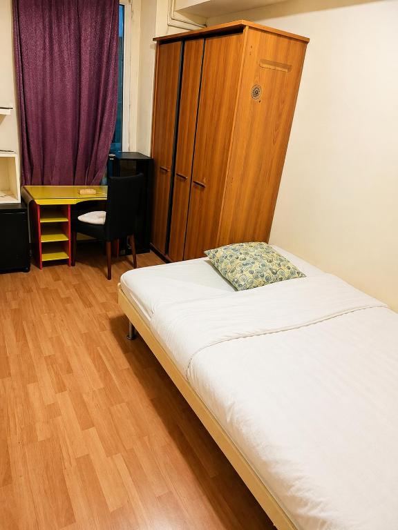 a bedroom with a bed and a cabinet and a desk at Private Room Pré-Saint-Gervais in Le Pré-Saint-Gervais