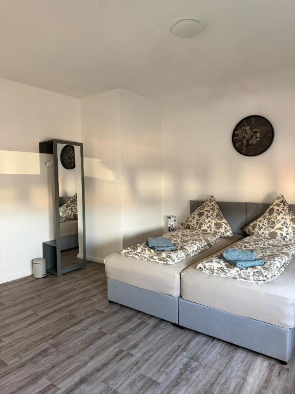 a living room with two beds and a mirror at Apartment Rotenburg in Rotenburg an der Fulda