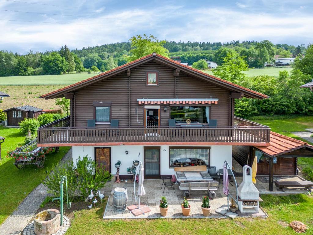 a house with a large deck on the front of it at Ferienwohnung Rihm in Arrach