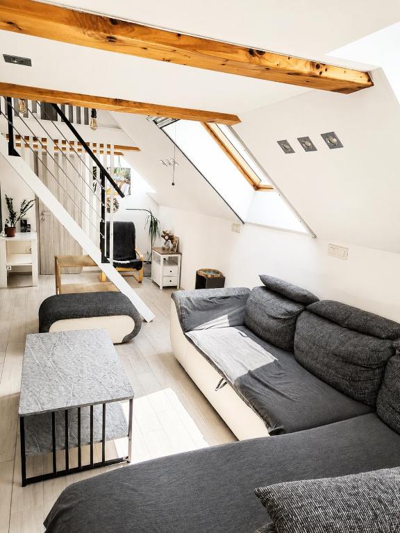a living room with a couch and a table at Apartment Loft Pejić - open space loft studio near Bovec, Soča Valley in Bovec