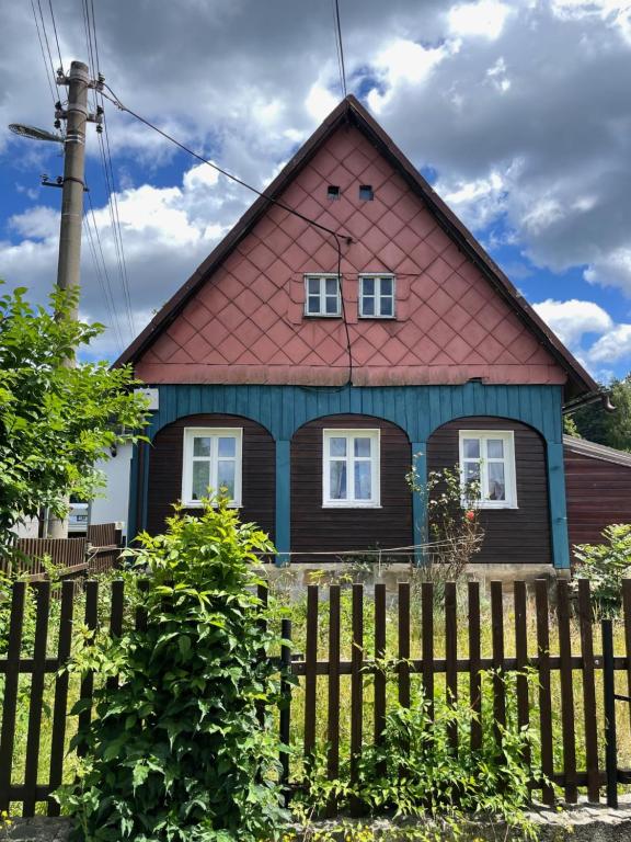 a house with a red roof and a fence at House Pankraz Jitrava in Rynoltice