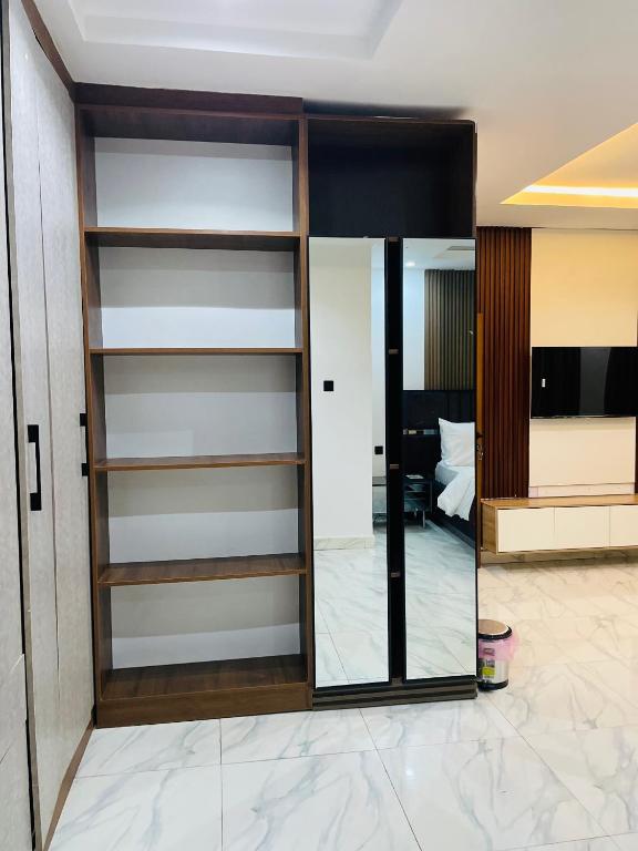 a glass door in a room with a bedroom at Soilsmart haven in Abuja