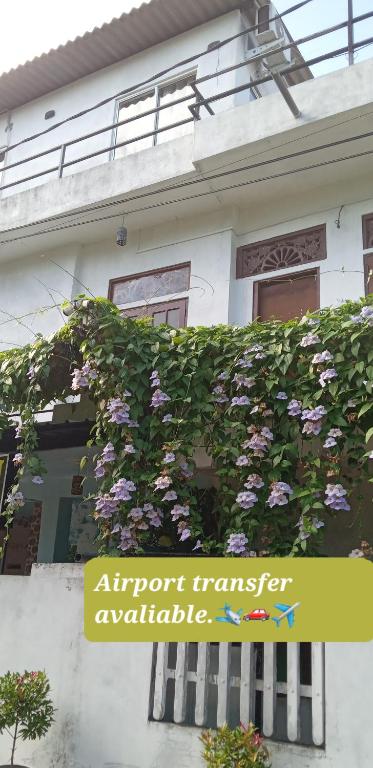 a house with purple flowers on the side of it at The Golden Bow in Seeduwa