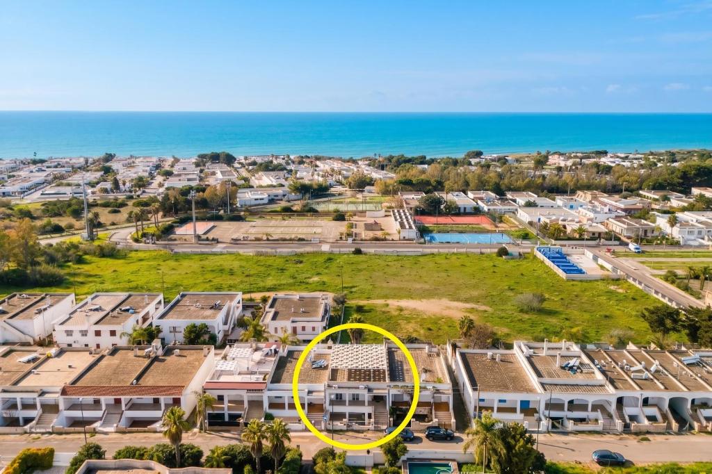 an aerial view of a resort with a yellow circle at Annamaria House by BarbarHouse in Marina di Mancaversa