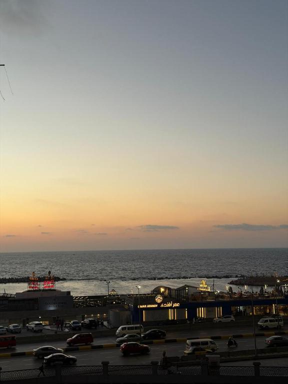 a parking lot next to the ocean at sunset at See side view city square 42 in Alexandria
