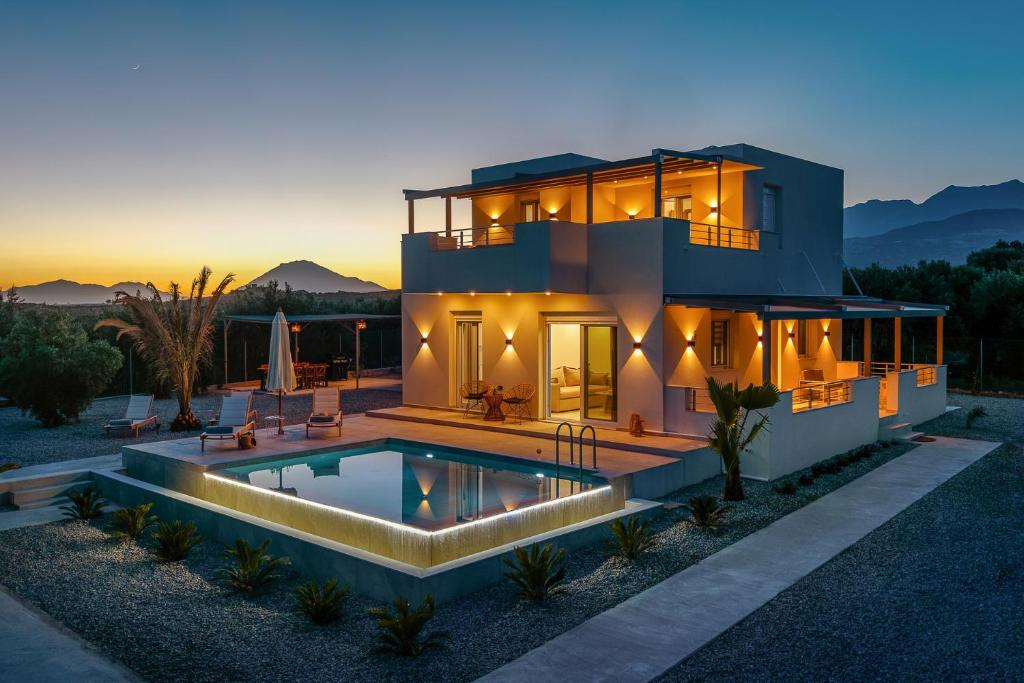 a house with a swimming pool in front of it at Paradise Garden Villa in Moírai